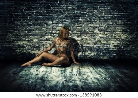 Nifty lady in underclothes with perfect figure by brick wall
