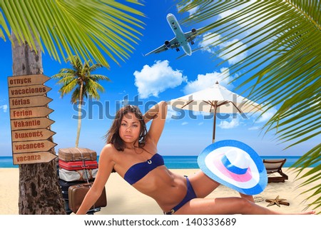 Young woman reaxing on the beach at exotic resort TRavel concept