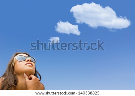 beautiful girl thinks something with white cloud ( copy space ) on the sky