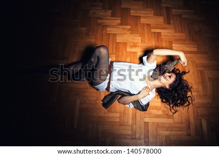 Beautiful sexy woman on wooden floor