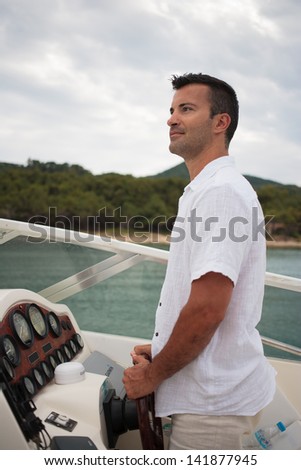Handsome Young man on his yacht