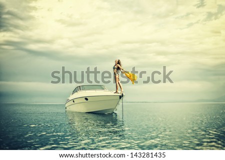 Young sexy woman in bikini enjoying  her private yacht
