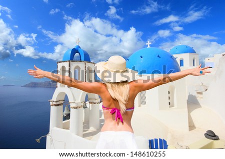 Young woman enjoying the view of Santorini island Greece