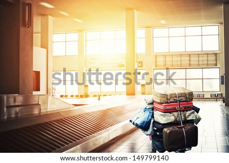 Suitcases on a cart at the airport arrival terminal