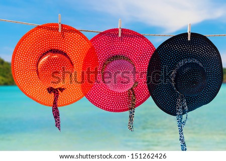 Three hats drying on the rope on Phi Phi island beach in Thailand
