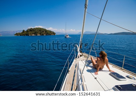 Young Woman Sailing On Yacht In Greece