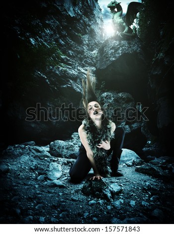 Sexy Woman with dragon in a cave
