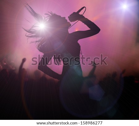 Female singer silhouette at rock concert