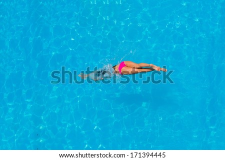 Top view of a girl diving in the swimming pool