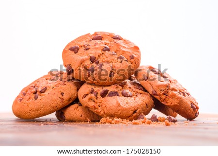 Stack of Chocolate chip cookies on wooden background. Stacked chocolate chip cookies shot with selective focus.