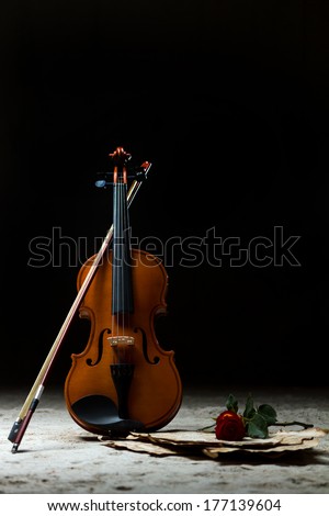 Violin sheet music and rose black composition still life music