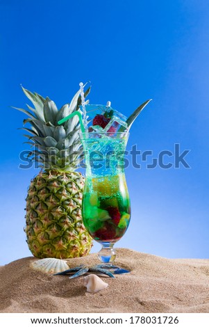 Mint, strawberry and pineapple cocktail over black background