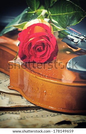 Violin sheet music and rose black composition still life music