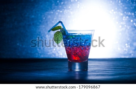 Layered cocktail with blue and red at the club