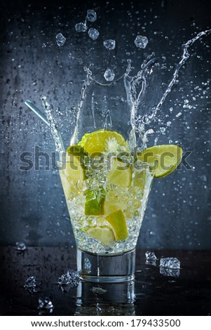 Mojito cocktail with fresh lime splashing at the club