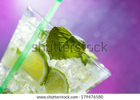 Mojito cocktail with fresh lime at the club - Selective focus