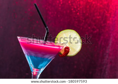 Fresh tropical layered cocktail with red hot chilli pepper