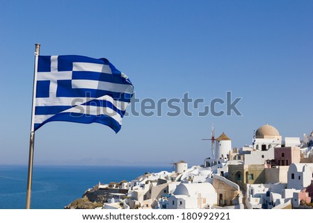 Greek flag with overview on Oia on the island of Santorini in Greece