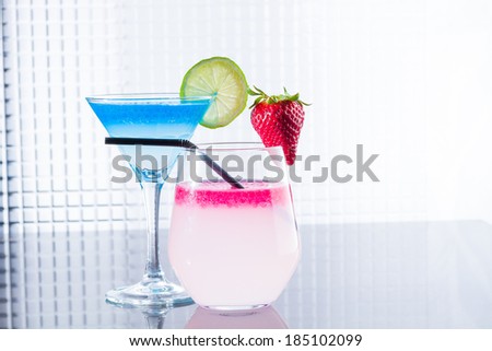 Molecular mixology - Cocktail with blue caracao and strawberry caviar in a martini glass