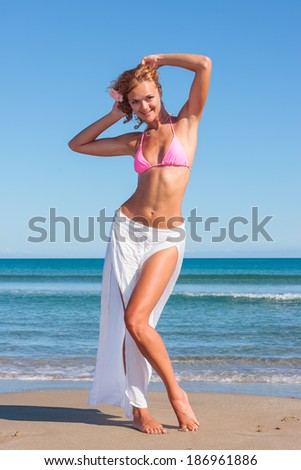 Young woman with white pants on the beach