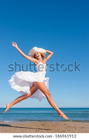 Young woman in white dress on the tropical beach