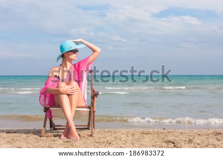 WOman sitting on a chair on the beach
