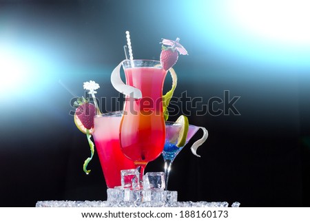 Party time - Fresh strawberry cocktail over black background