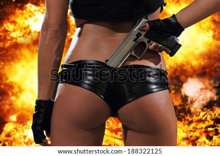 Hot blonde woman with gun over exploding background