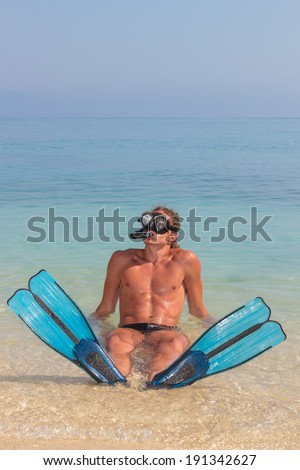 Funny scuba diver having fun at the beach