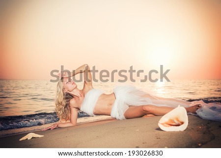 Beautiful Girl With White veil on The Beach at sunrise. T