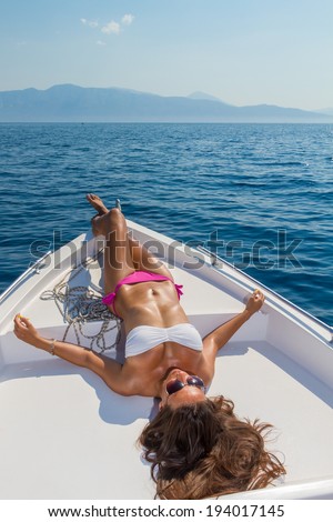 Young woman relaxing on a power speed boat