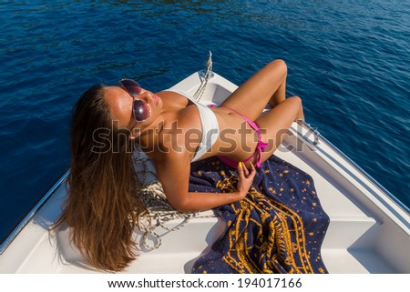 Young woman relaxing on a power speed boat