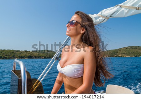 Summer vacation - young girl driving a motor power boat