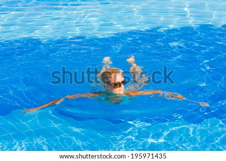 Woman in bikini enjoying the summer at the swimming pool