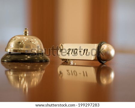 Reception - Hotel bell and key lying on the desk