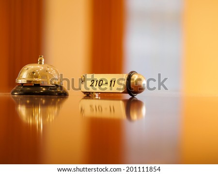 Reception - Hotel bell and key lying on the desk