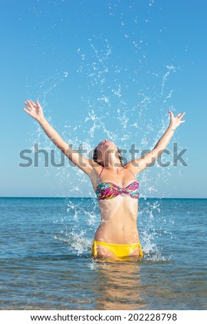 Beauty Model Girl Splashing Water in the ocean. Beautiful Woman in Water
