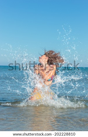 Beauty Model Girl Splashing Water in the ocean. Beautiful Woman in Water