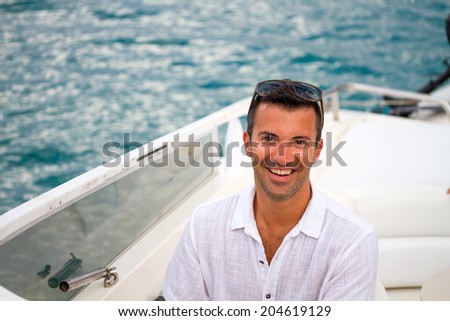 Handsome Young man on his yacht / powerboat