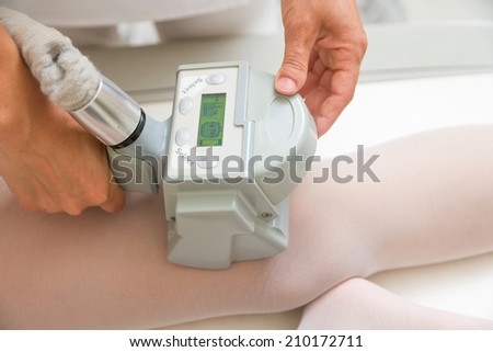 Therapist applying lipo massage LPG treatment - selective focus narrow DOF
