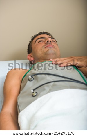 Man receiving an electro therapy at the health center