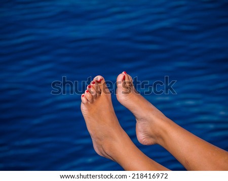 Beautiful woman feet above the water