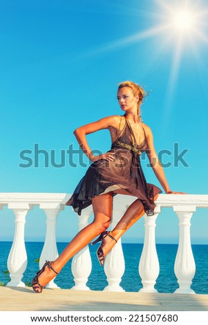 Beautiful young sexy fashion model by the sea in Greece