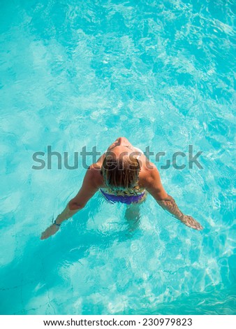 Young Woman in the swimming pool top view
