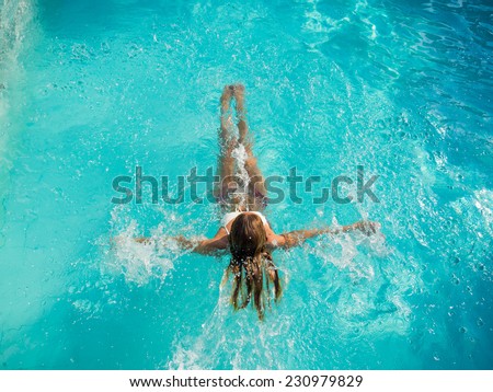 Young Woman in the swimming pool top view