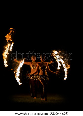 BALI, INDONESIA - NOVEMBER 20, 2014: Two Fire dancer with traditionnal costume , BALI, INDONESIA on NOVEMBER 20, 2014