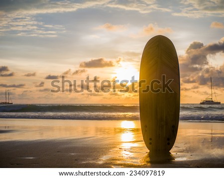 Surf board on the ocean beach at sunset on Bali island, Indonesia