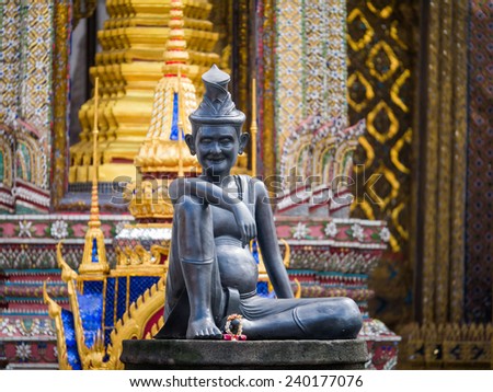 sitting figure on a stone capital in the Grand Palace, Bangkok Thailand