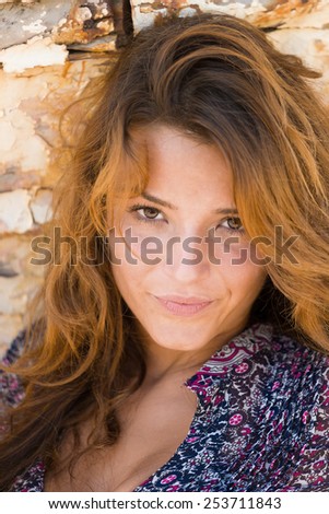 portrait of sexy brunette woman posing in front of shipwreck