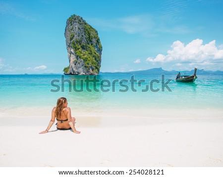 Woman in bikini sunbathing on the beach in Thailand